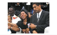 Mrs Justina Charles cries at the funeral