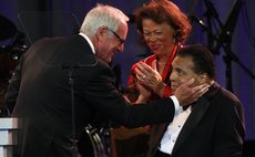 Producer Jerry Weintraub (L) touches the face of Muhammad Ali after receiving the Muhammad Ali Humanitarian Award during the Muhammad Ali Celebrity Fight Night awards banquet in Phoenix, Arizona March