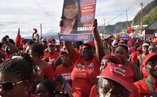 A supporter holds up a poster of the DLP candidate