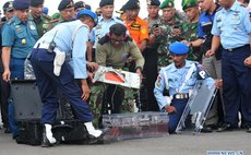 Indonesian military police carry the flight data recorder of the AirAsia Flight QZ8501 at Iskandar air base in Pangkalan Bun, Central Borneo, Indonesia, Jan. 12, 2015. 