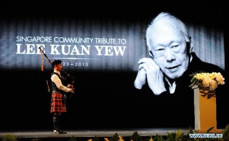 A bagpiper plays a tune during a memorial meeting of Singapore's founding father Lee Kuan Yew at Singapore's Kallang Theatre, March 27, 2015