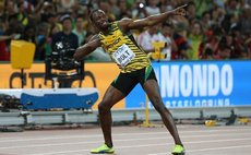 Bolt and his signature pose after winning the men's 100 metres race