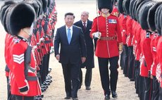 Chinese President Xi Jinping, accompanied by Prince Philip, inspects the guard of honor during a traditional ceremonial welcome held by British Queen Elizabeth II at the Horse Guards Parade in London,