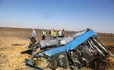 Rescue workers investigate at the crash site of the Russian passenger airplane which crashed at the Hassana area in Arish city, north Egypt, on November 1, 2015.