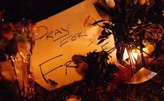 A card that reads "Pray for France" is placed outside the French Embassy in Washington D.C., Nov. 13, 2015. (Xinhua/Bao Dandan)