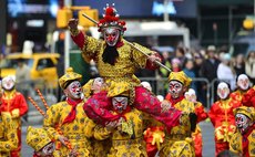 A flash mob featuring a hundred performers in monkey costumes makes an appearance to celebrate the arrival of the Chinese New Year in Times Square on Manhattan, New York, the United States, Feb. 6, 20