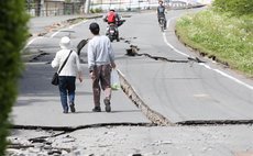 KUMAMOTO, April 16, 2016 (Xinhua) -- Residents walk on a street cracked by the earthquake in Mashiki, Kumamoto prefecture in southwestern Japan, April 16, 2016. 