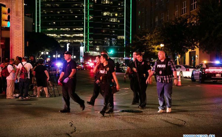 DALLAS, July 8, 2016 (Xinhua) -- Police cars gather around the El Centro College parking garage following the sniper shooting in downtown Dallas, the United States, July 7, 2016. 