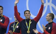 Michael Phelps (2nd, R) from the United States of America waves to the audience during the awarding ceremony for the men's 4x100m freestyle relay at the 2016 Rio Olympic Games in Rio de Janeiro