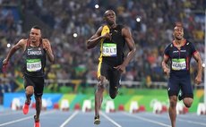 Usain Bolt of Jamaica (L) celebrates after the final of men's 100m at the 2016 Rio Olympic Games in Rio de Janeiro, Brazil, on Aug. 14, 2016. Usain Bolt won the gold medal with 9.81. (Xinhua/Lui Siu W