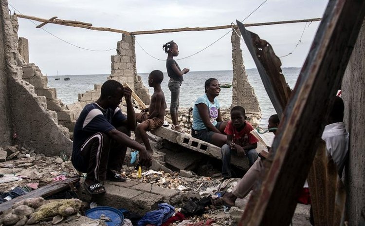  Image provided by the United Nations Children's Fund (UNICEF) shows people sitting on a structure devastated by Hurricane Matthew, in the neighborhood of La Savane, Les Cayes, Haiti, on Oct. 9, 2016