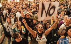 Demonstrators gather to protest a day after President-elect Donald Trump's victory, at a rally outside Los Angeles City Hall in Los Angeles, California, on November 9, 2016. (AFP/Xinhua)