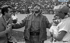 Undated file photo shows Fidel Castro (C) interacting with a journalist and a baseball player in Latinoamericano Stadium in Havana, Cuba