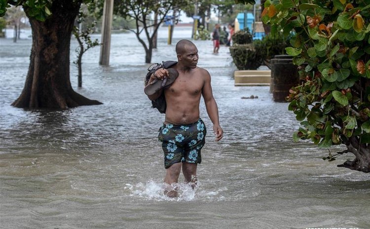 A man walks through a flooded street after the passage of Hurricane Irma, in Havana, Cuba, on Sept. 10, 2017. (Xinhua/Joaquin Hernandez)