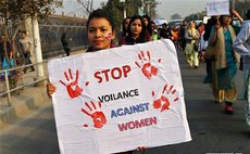 A woman holds a placard during a rally marking the International Women's Day with the theme of "Press for Progress" in Kathmandu, Nepal, March 8, 2018. (Xinhua/Sunil Sharma)