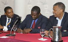 Hinds , centre, signs MOU with WICB officials