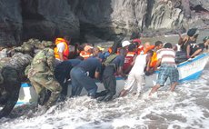 Small boat with Petite Savanne residents is being pushed from the shore at Petite Savanne