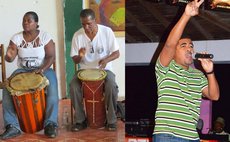 Lynard Henderson (R) in Sibouli/Massacre Cultural Group drumming ensemble and Peter Letang performing as "Mighty Pig-Tail" (Photo Courtesy: Neo-Xpressions Inc).