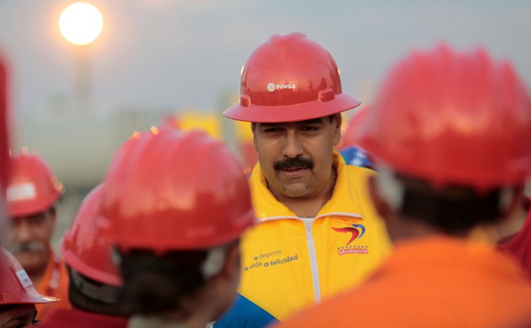 Venezuelan President Nicolas Maduro (C) meets with workers of Petroleum of Venezuela S.A., the state owned oil company, at the Guaraguao oil dock, Puerto la Cruz, Venezuela, March 20, 2013.  