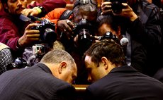 PRETORIA, Paralympic running star Oscar Pistorius (R) reacts inside the magistrates court in Pretoria, South Africa.