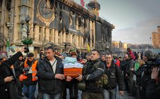 Protesters carry a coffin in the capital