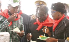 MARONDERA, Feb. 24 (Xinhua) -- Zimbabwe's President Robert Mugabe (C) eats a piece of cake with his wife Grace Mugabe and their son during celebrations to mark his 90th birthday  at Marondera, 75 km f