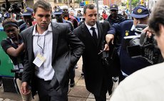 PRETORIA, March 5, 2014 (Xinhua) – S. African Paralympic athlete Oscar Pistorius (C) is escorted outside court during a recess on the third day of his trial at the high court in Pretoria, S. Africa.