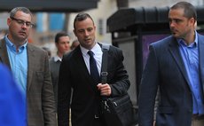 PRETORIA, March 6, 2014 (Xinhua) -- South African Paralympic athlete Oscar Pistorius(C) walks to the high court in Pretoria on the fourth day of his trial in Pretoria, South Africa.