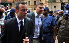 PRETORIA, March 10, 2014 (Xinhua) -- Oscar Pistorius (L) walks to Pretoria's North Gauteng High Court  in Pretoria, South Africa, on March 10, 2014, at the start of the second week Oscar Pistorius' mu