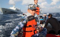 March 14, 2014 (Xinhua) -- Rescuers aboard the Chinese naval vessel Jianggangshan take a boat to possible crash site of missing Malaysia Airlines flight MH370, March 13, 2014