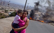 Woman and child near demonstration in Iquique, Chileon April 5,2014