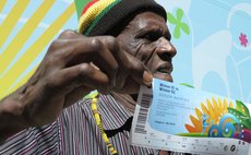 SAO PAULO, April 19, 2014 (Xinhua) -- A supporter poses with his tickets for the FIFA World Cup on the first ticket distribution day in Sao Paulo, Brazil, on April 18, 2014.