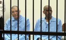 TRIPOLI, April 27, 2014 (Xinhua) -- Ex-intelligence chief of Libya Abdullah al-Senussi (R) and former Libyan foreign intelligence chief Bouzid Dorda in court in Tripoli, Libya, April 27, 2014. 