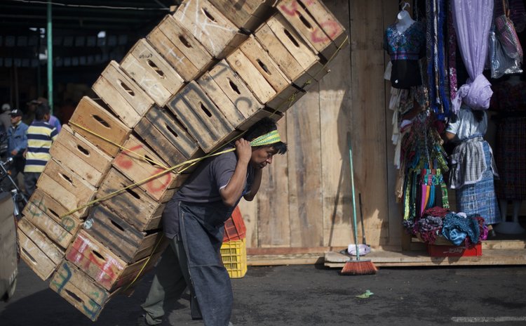 GUATEMALA CITY, May 2, 2014 (Xinhua) -- A man carries boxes at "La Terminal" market in Guatemala City, capital of Guatemala, on May 1, 2014, the International Labor Day. 