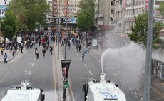 ANKARA, May 2, 2014 (Xinhua) – Demonstrators and police clash when the police try to disperse the protesting crowd by water cannon and gas, Ankara, Turkey, May 1, 2014