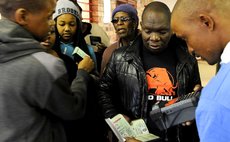 PRETORIA, May 7, 2014 (Xinhua) -- A staff worker checks voters' identities at a poll station in Pretoria, South Africa, May 7, 2014. 