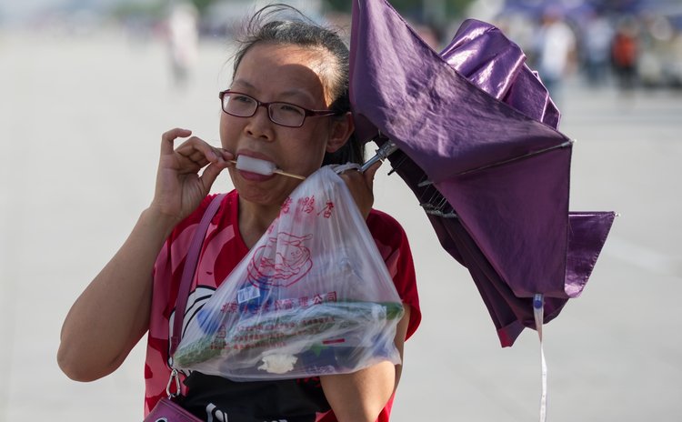BEIJING, May 29, 2014 (Xinhua) -- A tourist eats a frozen sucker at the Beijing Olympic Park in Beijing, capital of China, May 29, 2014