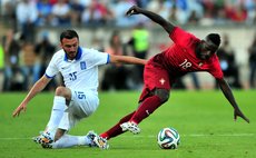 LISBON, June 1, 2014 (Xinhua) -- Portugal's Silvestre Varela (L) vies with Greece's Vasilis Torosidis during the friendly football match at the Jamor National stadium in Oeiras, Portugal, on May 31, 2
