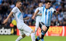 LA PLATA, June 8, 2014 (Xinhua) -- Argentina's Lionel Messi (R) vies for the ball with Branko Ilic of Slovenia during the friendly match at Ciudad de La Plata Stadium, Argentina, on June 7, 2014