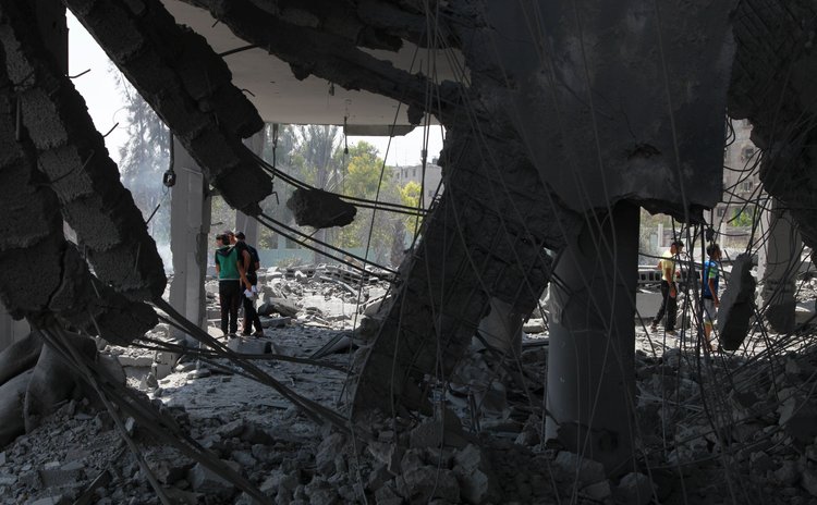 GAZA, Aug. 2, 2014 (Xinhua) -- Palestinians search on the debris of a destroyed mosque after an Israeli airstrike in Gaza City, on Aug. 2, 2014. 