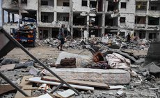 GAZA STRIP, Aug. 4, 2014 (Xinhua) -- A Palestinian boy rests on a mattress as he collects belongings from his destroyed house in the northern Gaza Strip town of Beit Lahiya, on Aug. 4, 2014