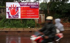 FREETOWN, Aug. 18, 2014 (Xinhua) -- People ride past a board with control and prevention information of the Ebola epidemic outbreak in the Ebola-affected Freetown, capital of Sierra Leone, Aug. 17, 20