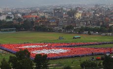 KATHMANDU, Aug. 23, 2014 (Xinhua) -- Nepalese people participate in breaking the Guiness World Record of "Largest Human National Flag" in Kathmandu, Nepal, Aug. 23, 2014. 