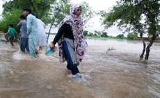 GUJRANWALA, Sept. 7, 2014 (Xinhua) -- Pakistani people wade through flooded water in eastern Pakistan's Gujranwala on Sept. 6, 2014