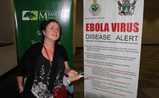 HARARE, Oct. 6, 2014 (Xinhua) -- A passenger holds a pamphlet on ebola prevention as she arrives at Harare International Airport, Zimbabwe, Oct. 6, 2014