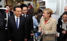 Oct. 11, 2014 (Xinhua) -- Chinese Premier Li Keqiang (L Front) and German Chancellor Angela Merkel (R Front) visit a supermarket in Berlin, Germany, Oct. 10, 2014