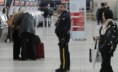 VANCOUVER, Oct. 23, 2014 (Xinhua) -- A policeman patrols at departure hall of Vancouver International Airport in Vancouver, Canada, Oct. 22, 2014. 