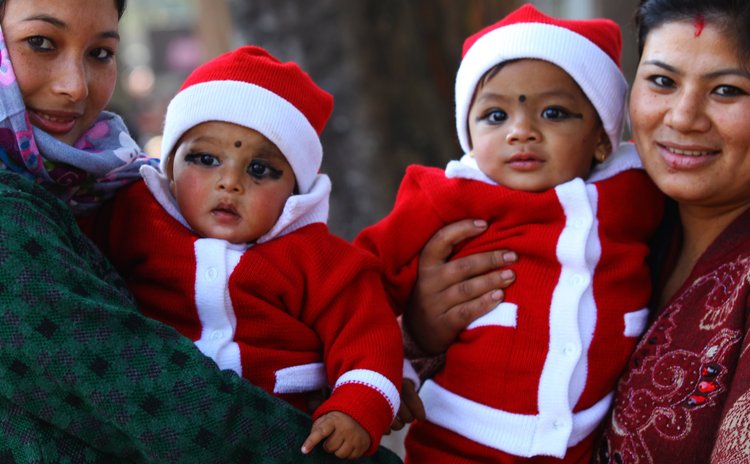LALITPUR, Dec. 25, 2014 (Xinhua) -- Nepalese children are seen with their mothers during the celebration of Christmas at Jawalakhel in Lalitpur, Nepal, Dec. 25, 2014. (Xinhua/Sunil Sharma)