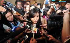 SINGAPORE, Dec. 28, 2014 (Xinhua) -- A fiancee (C) of a passenger on AirAsia flight QZ8501 speaks to the media at Singapore's Changi Airport, on Dec. 28, 2014. 