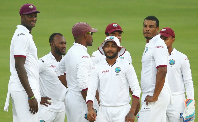Bishoo (with hat) celebrates 8 wicket haul